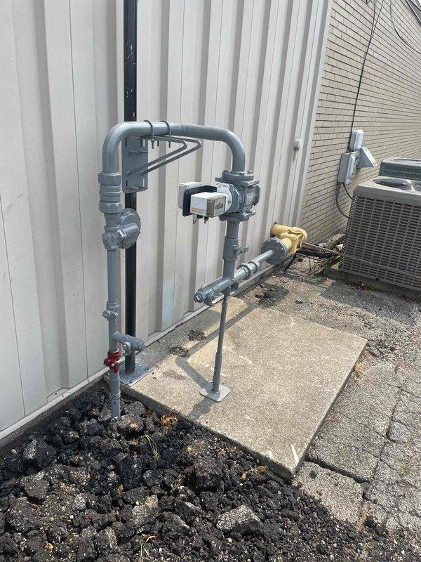 Responded to gas leak investigation following utility company meter replacement. The utility provider had detected a gas leak during new meter installation and disconnected service pending repair. Performed comprehensive leak detection inspection of exterior gas piping system, including meter assembly, vertical pipe runs, and associated fittings mounted on building exterior. Inspected all joints, connections, elbows, and valve assemblies using leak detection equipment. Examined PVC gas line configuration from ground level through rooftop penetration, checking integrity of all pipe sections and fittings. Documented existing piping layout and condition of gas distribution system components for further diagnostic evaluation and repair recommendations.