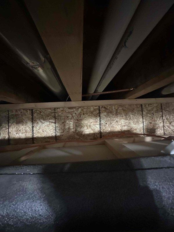 Responded to no hot water condition affecting entire residence. Upon arrival, inspected 4-year-old tankless water heater unit that had failed to restart after customer attempted reset per previous instruction. Performed diagnostic evaluation of unit mounted in utility area, examining electrical connections, gas supply lines, and control board functionality. Verified no water leakage present at installation point. Assessed PVC venting system, copper water lines, and electrical panel connections serving the unit. Documented current system configuration including plumbing distribution network and HVAC integration in crawl space area. Unit remained non-operational following standard troubleshooting procedures, requiring further diagnostic work to identify component failure and determine necessary repairs to restore hot water service to property.