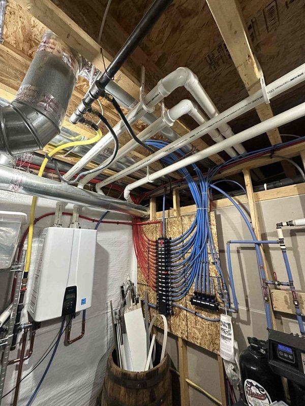 Responded to no hot water condition affecting entire residence. Upon arrival, inspected 4-year-old tankless water heater unit that had failed to restart after customer attempted reset per previous instruction. Performed diagnostic evaluation of unit mounted in utility area, examining electrical connections, gas supply lines, and control board functionality. Verified no water leakage present at installation point. Assessed PVC venting system, copper water lines, and electrical panel connections serving the unit. Documented current system configuration including plumbing distribution network and HVAC integration in crawl space area. Unit remained non-operational following standard troubleshooting procedures, requiring further diagnostic work to identify component failure and determine necessary repairs to restore hot water service to property.