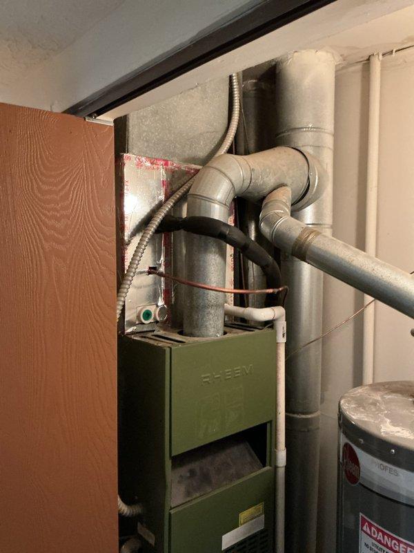 Completed installation of Lennox ML13KC1-024 air conditioning system with matching ADP evaporator coil. The outdoor condensing unit was positioned on a prepared pad against the exterior wall with proper clearances maintained from surrounding vegetation, and the evaporator coil was integrated with the existing Slant/Fin furnace system in the basement utility area. All refrigerant lines, electrical connections, and ductwork transitions were properly installed and sealed to ensure optimal system performance.