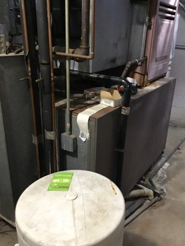 Conducted on-site evaluation for rooftop AC unit replacement at residential property with non-functioning existing system. Assessed mechanical room containing water heater, boiler/furnace assembly, and associated copper piping infrastructure. Evaluated basement utility area with exposed ductwork, electrical panel, and existing HVAC equipment to determine replacement specifications and installation requirements. Documented equipment conditions and utility connections to prepare comprehensive replacement estimate for new rooftop package unit system.