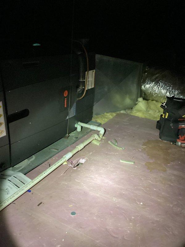 Responded to no cooling complaint on a 10-year-old system with no airflow from vents and no tripped breakers. Upon inspection, accessed attic-mounted air handler and ductwork system, documenting heavy dust accumulation throughout mechanical space and on equipment surfaces. Performed diagnostic evaluation of air handler unit and associated ductwork connections to determine cause of system failure.