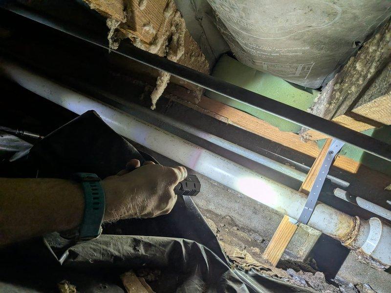Responded to inspection concern regarding loose sewer line supports in crawlspace. Upon arrival, accessed crawlspace and performed visual inspection of PVC sewer piping and existing support system. Inspected mounting straps, hangers, and brackets securing horizontal sewer line runs to floor joists. Verified proper pipe slope and alignment throughout accessible areas. Documented current condition of pipe supports, insulation, and surrounding crawlspace infrastructure with photographs for record.