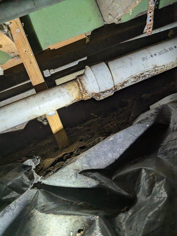 Responded to inspection concern regarding loose sewer line supports in crawlspace. Upon arrival, accessed crawlspace and performed visual inspection of PVC sewer piping and existing support system. Inspected mounting straps, hangers, and brackets securing horizontal sewer line runs to floor joists. Verified proper pipe slope and alignment throughout accessible areas. Documented current condition of pipe supports, insulation, and surrounding crawlspace infrastructure with photographs for record.