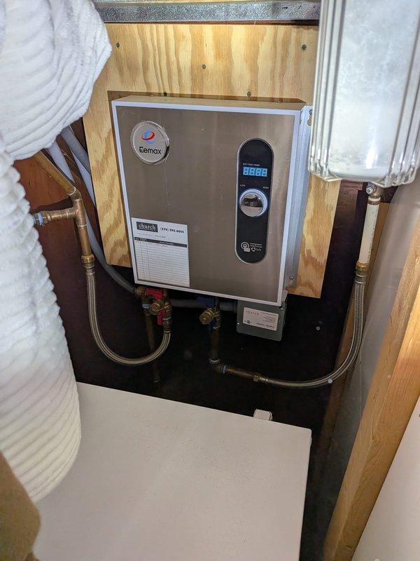 Responded to kitchen sink clogged and backing up into the basin. Customer reported chemicals had been used several days prior without success. Confirmed issue was isolated to single fixture with no gurgling in toilets or backup into other drains. Performed diagnostic assessment of kitchen drain line to determine blockage location and severity. Documented existing plumbing configuration including tankless water heater and water filtration system installation for service records.