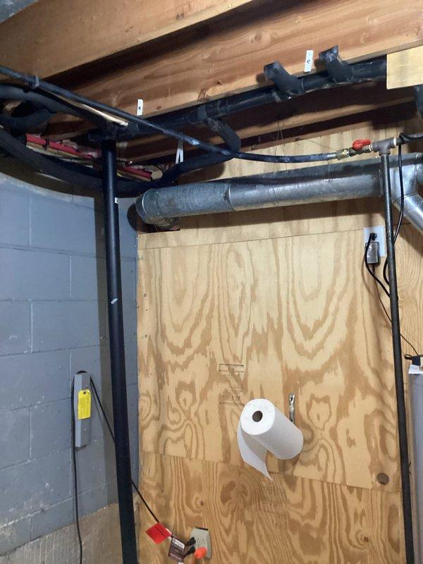 Completed gas line installation in basement utility area per quoted specifications. Picked up necessary fittings and ran new black iron gas piping along ceiling joists, properly secured to existing structure with appropriate mounting hardware. All connections made to code with proper routing through unfinished basement space, terminating at designated appliance locations including water heater area.