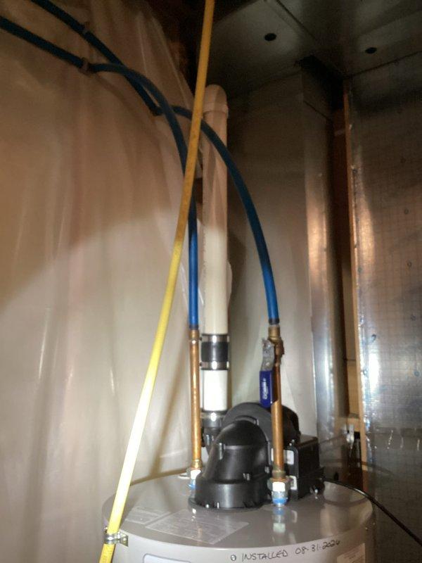 Completed installation of Bradford White Defender Safety System tanked water heater in residential basement utility area. Removed existing unit and installed new water heater in drain pan with proper drainage piping to floor drain as specified. Connected all copper supply and discharge lines, installed yellow flexible gas line with appropriate fittings, and completed electrical connections. Replaced grinder pump as part of scope of work. Verified all plumbing connections for leaks, tested gas connections for safety, and confirmed proper operation of new water heater and safety systems. Protected work area with tarps during two-flight stair access to prevent damage to interior surfaces. All installations meet code requirements and manufacturer specifications.