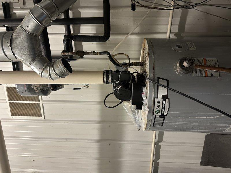 Conducted phone consultation for water heater replacement estimate. Reviewed existing 75-gallon propane tank water heater with power vent configuration. Documented current HVAC and mechanical system setup through site photos showing furnace installation, ductwork configuration, and utility room conditions to assess installation requirements and clearances for new water heater unit.