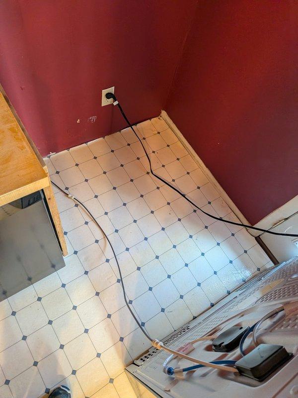 Responded to service call for refrigerator ice maker water line issue and main drain line concerns. Inspected main drain line system showing signs of corrosion and potential structural concerns requiring access through ceiling/wall opening. Assessed exposed plumbing infrastructure including PVC drainage piping and support brackets to determine condition and necessary corrective measures.