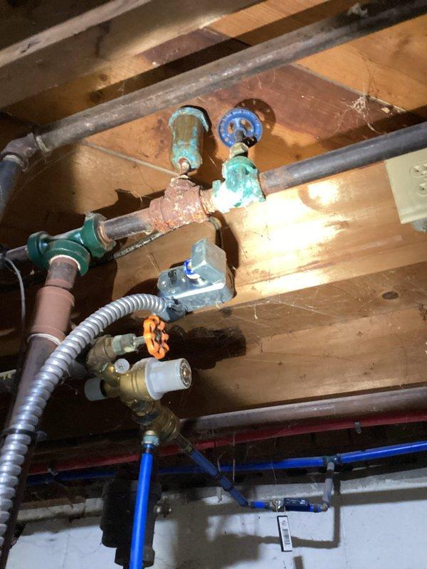 # HVAC Maintenance Summary

Completed routine preventive maintenance inspection on residential HVAC system. All operational parameters verified within normal specifications with no deficiencies identified. System operating efficiently with no service requirements at this time.

# Detailed Work Performed

Performed comprehensive planned maintenance service on residential HVAC equipment. Conducted thorough visual inspection of accessible system components and infrastructure. Documented existing plumbing and mechanical installations in basement/crawl space area for service records.

Inspected exposed piping infrastructure including copper supply lines, PEX distribution piping, and associated valve assemblies. Observed multiple shut-off valves with age-appropriate patina and oxidation on brass/bronze fittings. Noted presence of flexible metal conduit, various pipe mounting hardware, and properly secured blue PEX tubing runs along floor joists.

Examined structural mounting of plumbing comp