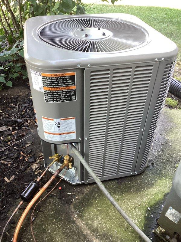 Completed installation of new outdoor air conditioning condenser unit on existing concrete pad. Installed ML13KC1-024 model with matching ADP coil that was picked up from Mid-City Elkhart. Connected refrigerant lines using copper piping with proper insulation, installed brass service valves and fittings, and completed all electrical connections using flexible conduit. Unit is operational and positioned on concrete pad with proper clearances for airflow and service access.
