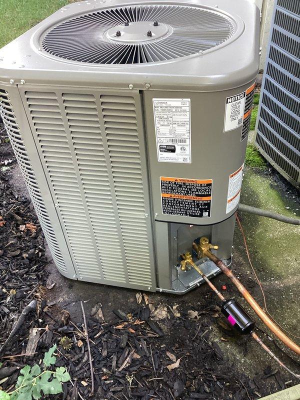 Completed installation of new outdoor air conditioning condenser unit on existing concrete pad. Installed ML13KC1-024 model with matching ADP coil that was picked up from Mid-City Elkhart. Connected refrigerant lines using copper piping with proper insulation, installed brass service valves and fittings, and completed all electrical connections using flexible conduit. Unit is operational and positioned on concrete pad with proper clearances for airflow and service access.
