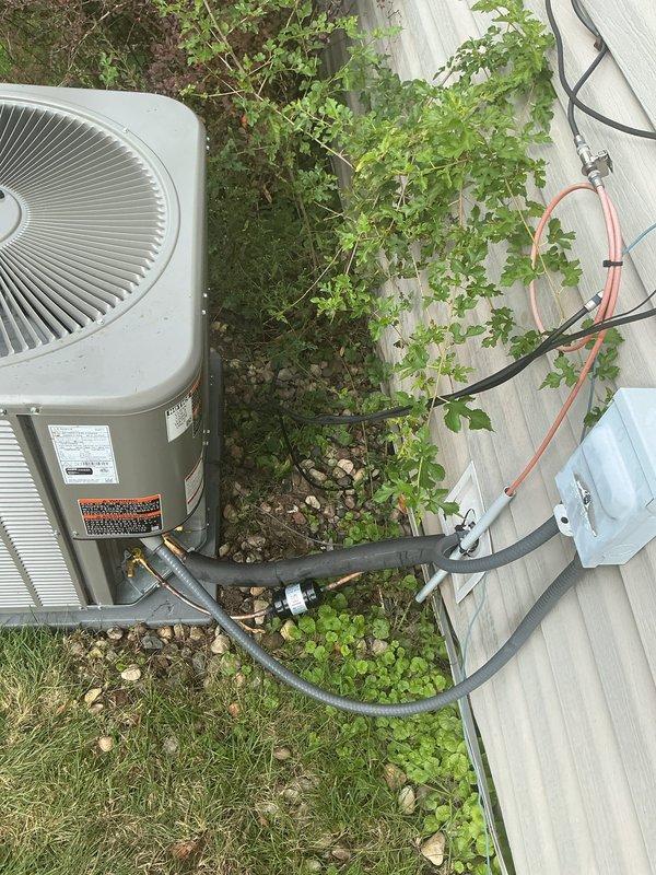 Completed full HVAC system installation including new Lennox furnace, air conditioning condenser unit, and thermostat. Installed furnace in basement mechanical room with proper PVC condensate drainage and venting, connected to existing ductwork and plenum system. Positioned outdoor condenser unit on concrete pad adjacent to property fence, ran refrigerant lines to interior equipment, and completed all electrical connections. Reused existing air cleaner as specified. System tested and operational upon completion.