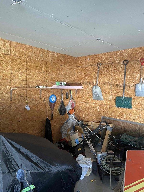 Performed site inspection to assess natural gas line installation requirements from existing meter location at house to detached garage approximately 110 feet away. Evaluated current gas meter assembly mounted on exterior brick wall, noting existing pipe configuration and connection points. Assessed routing path across property to determine optimal trench location, accounting for obstacles and grade changes. Inspected garage interior construction and wall composition to plan proper termination point and interior rough-in requirements. Documented existing conditions with photographs for estimate preparation, including current meter setup and proposed endpoint location in storage structure.