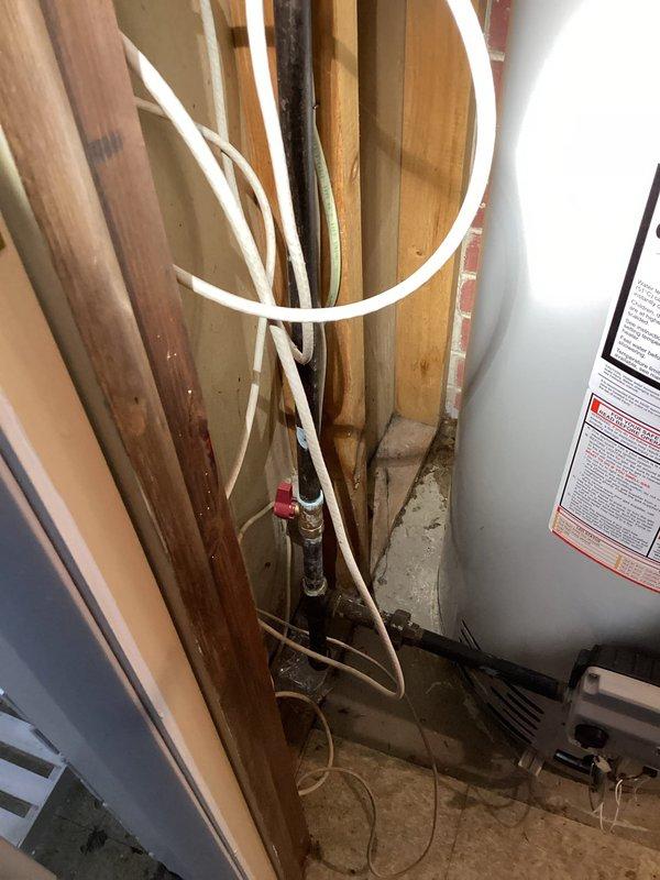 Responded to report of water leakage around HVAC unit in basement. Upon arrival, inspected one-year-old system that was operating normally for heating and cooling functions. Located source of water accumulation on concrete floor near unit and floor drain. Examined condensate drain line connections and verified proper drainage pathway. Identified condensate management issue causing water to pool on basement floor rather than draining appropriately through existing floor drain system. Cleared obstruction in condensate line, tested drainage flow, and confirmed water was properly evacuating through drain. Verified all mechanical components functioning within normal parameters and no damage to unit from moisture exposure. System returned to normal operation with resolved drainage issue.