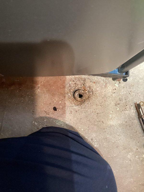 Responded to report of water leakage around HVAC unit in basement. Upon arrival, inspected one-year-old system that was operating normally for heating and cooling functions. Located source of water accumulation on concrete floor near unit and floor drain. Examined condensate drain line connections and verified proper drainage pathway. Identified condensate management issue causing water to pool on basement floor rather than draining appropriately through existing floor drain system. Cleared obstruction in condensate line, tested drainage flow, and confirmed water was properly evacuating through drain. Verified all mechanical components functioning within normal parameters and no damage to unit from moisture exposure. System returned to normal operation with resolved drainage issue.