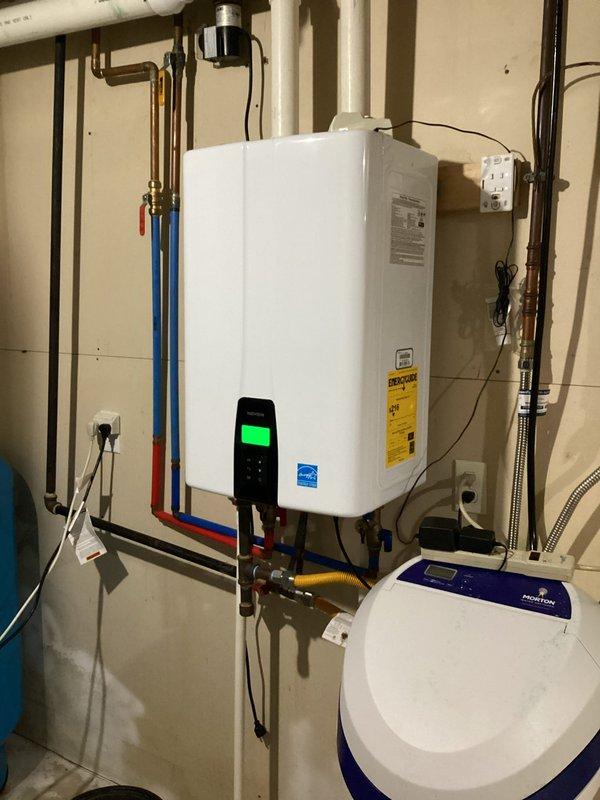 Performed annual maintenance service on Navien NPE-A40A2N tankless water heater unit. Completed full system flush to remove mineral buildup and scale deposits from heat exchanger, descaled unit using appropriate cleaning solution, and verified proper operation of all components including gas line connections, water supply lines, shut-off valves, and digital control panel. Inspected associated plumbing connections, copper piping, flexible water lines, brass fittings, and adjacent water treatment system for any signs of leaks or deterioration.