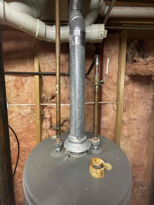 Conducted comprehensive assessment of existing A.O. Smith traditional tank-style water heater showing signs of failure requiring replacement. Evaluated current installation configuration including overhead copper and PVC supply lines, venting system with vertical flue pipe, and proximity to existing water treatment equipment. Documented mechanical room conditions, available clearances, and existing plumbing connections to provide accurate replacement estimate and equipment recommendations.