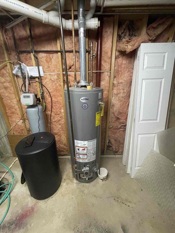 Conducted comprehensive assessment of existing A.O. Smith traditional tank-style water heater showing signs of failure requiring replacement. Evaluated current installation configuration including overhead copper and PVC supply lines, venting system with vertical flue pipe, and proximity to existing water treatment equipment. Documented mechanical room conditions, available clearances, and existing plumbing connections to provide accurate replacement estimate and equipment recommendations.