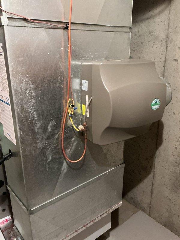Completed full HVAC system installation in residential basement mechanical room, including new furnace unit with integrated humidifier system. Installed all necessary refrigerant lines, electrical connections, and PVC condensate drainage piping, with system mounted on concrete pad and secured to specifications. All components tested and operational, with customer payment collected in full via check upon completion.