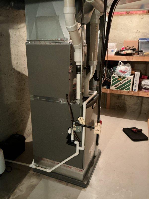 Completed full HVAC system installation in residential basement mechanical room, including new furnace unit with integrated humidifier system. Installed all necessary refrigerant lines, electrical connections, and PVC condensate drainage piping, with system mounted on concrete pad and secured to specifications. All components tested and operational, with customer payment collected in full via check upon completion.