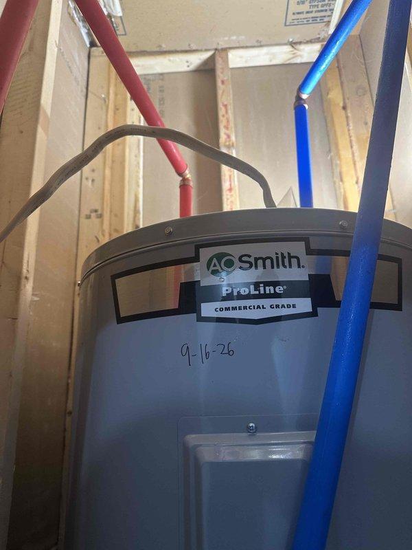 Removed and replaced existing 50-gallon conventional storage tank water heater with new A.O. Smith ProLine commercial grade unit in utility closet. Connected hot and cold water supply lines, installed pressure relief valve discharge piping, and verified all connections for proper operation and absence of leaks.