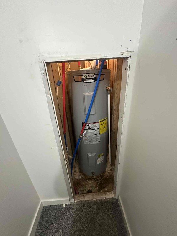 Removed and replaced existing 50-gallon conventional storage tank water heater with new A.O. Smith ProLine commercial grade unit in utility closet. Connected hot and cold water supply lines, installed pressure relief valve discharge piping, and verified all connections for proper operation and absence of leaks.