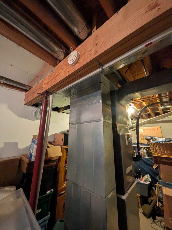 Conducted on-site consultation and assessment for whole-home dehumidifier installation to integrate with newly installed HVAC system. Evaluated existing ductwork configuration in basement utility area and identified optimal integration points for dehumidifier connection to main supply plenum. Documented current HVAC infrastructure including main trunk line routing and available installation space, and photographed indoor air distribution system to develop comprehensive installation proposal for humidity control enhancement.