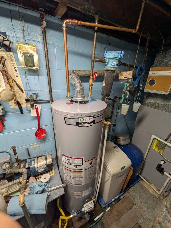 Responded to no hot water complaint at residential property. Upon arrival, performed diagnostic evaluation of A.O. Smith electric storage tank water heater, model ES12-50R560V 110, rated at 240 volts, single phase, 5500 watts. Unit is approximately 9 years old with parts-only warranty coverage remaining.

Conducted visual inspection of water heater installation in utility area. Confirmed no visible leaks, corrosion, or water pooling at base of tank. Verified proper connections of copper supply and discharge piping, pressure relief valve operation, and electrical connections. Inspected condition of heating elements and thermostat controls. Documented current installation configuration including associated plumbing connections, water softener system, and electrical panel proximity.

Photographed unit specifications, installation setup, and surrounding mechanical systems for service records. Verified all safety devices and components were accessible and properly installed per manufacturer