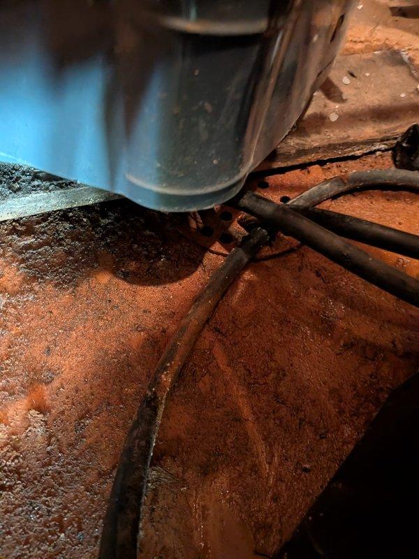 Responded to service call for progressively declining water pressure and intermittent leak in garage area near water softener and water heater. Upon inspection, discovered severe corrosion on water heater tank and associated plumbing connections, with extensive rust accumulation on threaded pipe fittings and metal surfaces indicating prolonged moisture exposure. The corroded components and deteriorated fittings were identified as the source of both the pressure loss and the random leaking pattern reported by the homeowner. Documented existing conditions showing advanced oxidation on copper fittings, compromised tank integrity, and aging infrastructure requiring immediate attention to restore proper water pressure and eliminate leak source.