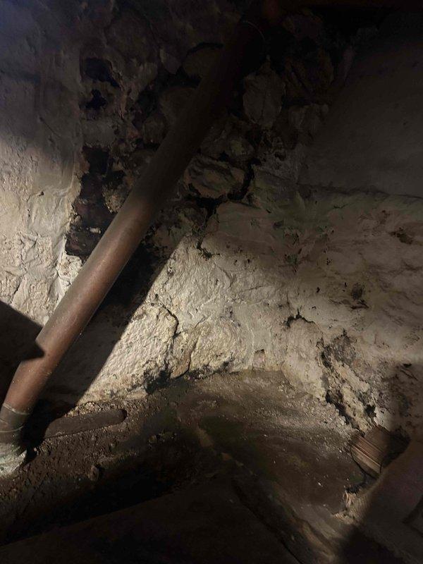 Responded to clogged basement sink with sewer odor. Accessed drain line in crawl space and inspected plumbing infrastructure. Cleared blockage from sink drain line using appropriate drain cleaning equipment. Verified proper drainage and flow restoration. Inspected surrounding copper piping for corrosion and potential issues that could affect drainage system. Confirmed single fixture issue with no backup into other drains or fixtures. Tested drain flow and verified elimination of sewer smell upon completion.