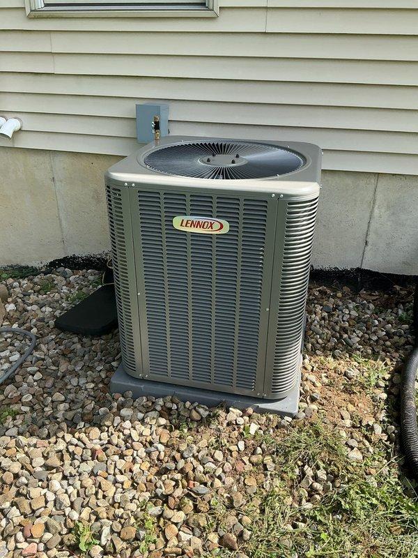 Completed full HVAC system installation at residential property. Installed new Lennox outdoor condensing unit on composite pad with proper gravel base for drainage and equipment stability. Unit positioned against exterior wall with appropriate clearances for airflow and service access. Connected electrical service with disconnect box mounted to building exterior per code requirements. Reused existing thermostat as requested by customer, verifying compatibility with new system. Performed refrigerant charging procedures using calibrated gauges and recovery equipment. Tested all electrical connections, verified proper voltage and amperage draw. Confirmed unit operation including compressor function, fan motor performance, and overall system cycling. All work completed to manufacturer specifications and local building codes.