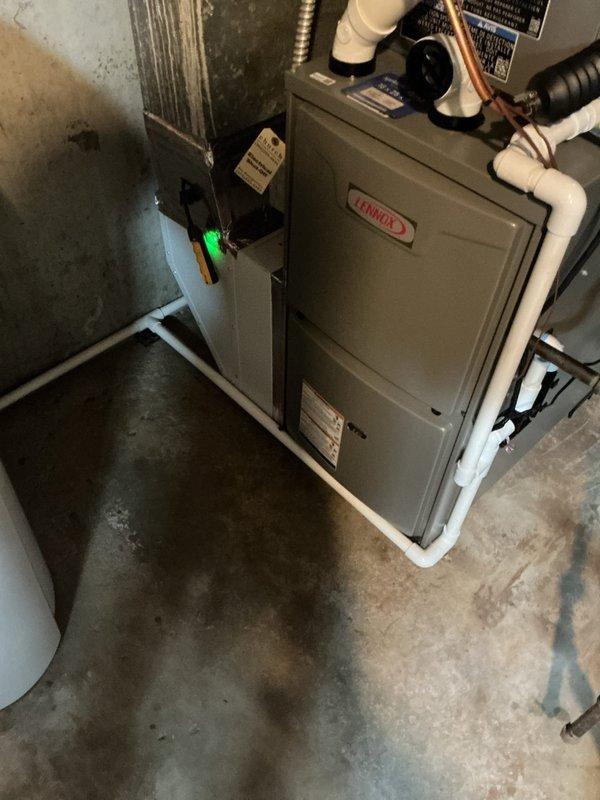 Completed full HVAC system installation in basement utility area consisting of Lennox ML196UH070 high-efficiency modulating furnace, ML13KC1-036 condenser unit, CK40CT-30B evaporator coil, Model 1610 humidifier, Model 600 humidifier, Air Scrubber air purification system, and Lennox S200 programmable thermostat. Installed all necessary PVC venting, refrigerant line sets with copper tubing, condensate drainage piping, and flexible ductwork connections. Mounted furnace and air handler on concrete floor per manufacturer specifications, established proper clearances, and completed all electrical connections including low-voltage thermostat wiring. Installed humidification system with water supply line and integrated air purification technology into supply plenum. Charged refrigerant system to manufacturer specifications, verified proper superheat and subcooling values, and performed complete system startup. Programmed S200 thermostat for optimal comfort and efficiency settings. Conducted th
