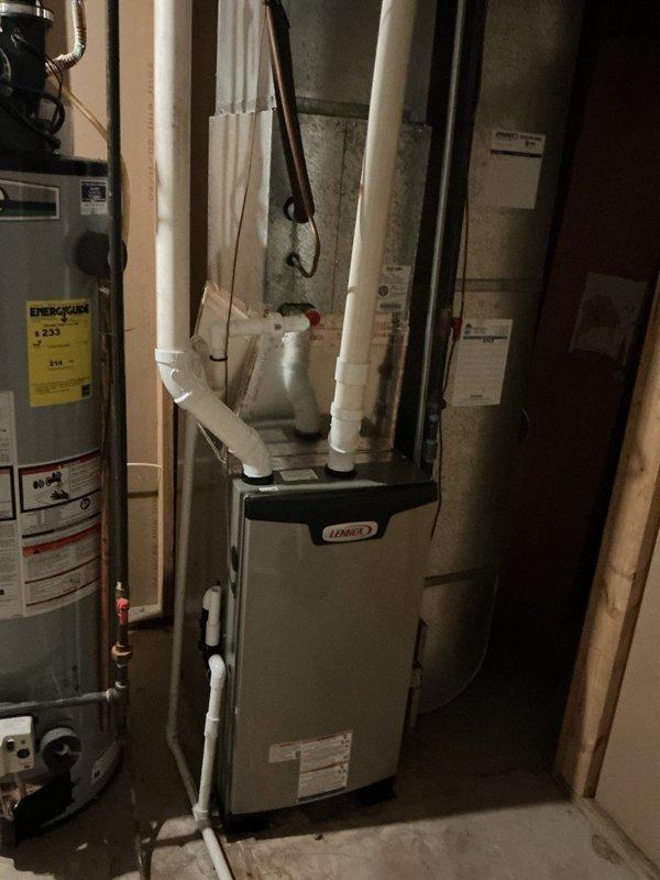 Completed installation of Lennox EL297UH070 high-efficiency furnace with S200 thermostat in residential basement mechanical room. Performed complete demolition and removal of existing furnace, installed new unit with PVC venting and condensate drainage system, reused existing filtration system, and verified proper operation of all components upon startup.