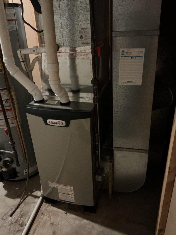 Completed installation of Lennox EL297UH070 high-efficiency furnace with S200 thermostat in residential basement mechanical room. Performed complete demolition and removal of existing furnace, installed new unit with PVC venting and condensate drainage system, reused existing filtration system, and verified proper operation of all components upon startup.
