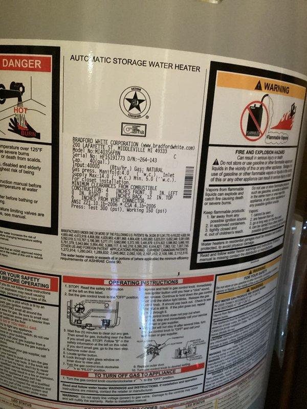 Responded to service call for 10-year-old Bradford White 40-gallon residential gas water heater with no hot water production. Customer reported pilot light would not reignite after following standard relighting procedures. Upon arrival, performed diagnostic inspection of unit including examination of gas control valve, thermocouple, pilot assembly, and burner components. Verified gas supply to unit and checked for proper venting through exhaust flue system. Inspected flexible water supply connections and confirmed no visible leaks present at tank or connections. Documented existing installation configuration including braided stainless steel supply lines and proper venting arrangement with metallic exhaust pipe. Unit equipped with standard safety features and manufacturer labeling intact showing capacity specifications and safety warnings. Assessed overall condition of water heater installation in residential utility area.