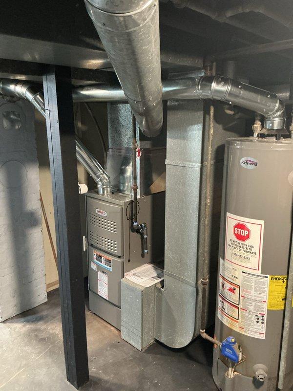 Completed installation of new gray furnace unit in basement mechanical room with full ductwork integration and upward venting system. Installed stainless steel chimney liner to ensure proper exhaust ventilation and code compliance. Mounted new Honeywell Home ProSeries digital thermostat on main floor with professional wall finishing and patching around installation area. All equipment tested and verified operational with proper airflow and temperature control functionality.