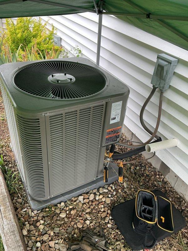 Completed full HVAC system installation at residential property, including outdoor condenser unit positioned on gravel pad with proper electrical disconnect and refrigerant line connections. System was professionally installed, tested, and confirmed operational with financing paperwork processed and finalized on-site.