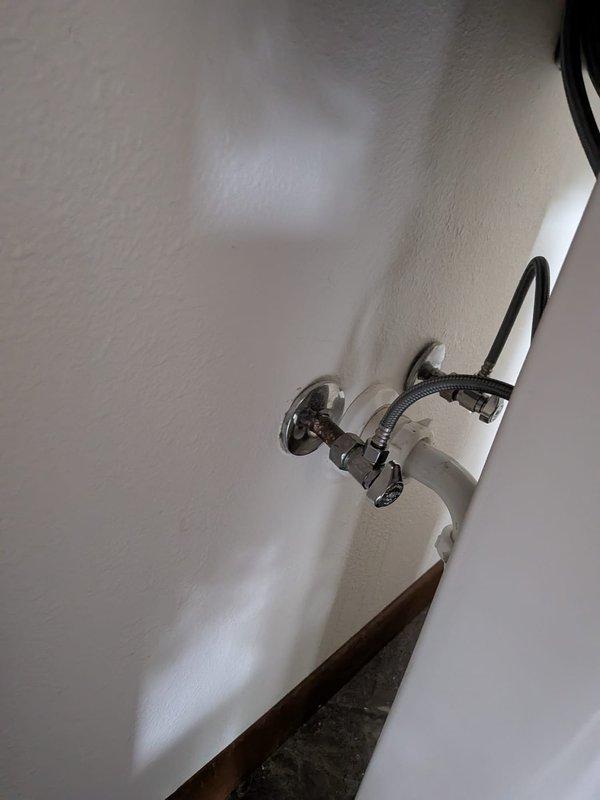 Replaced Delta single-handle faucet on pedestal sink in bathroom. Successfully accessed wall-mounted supply lines and connections without damaging wall surface or creating visible openings. Completed installation with chrome shut-off valve and braided supply line, ensuring proper water flow and leak-free operation.
