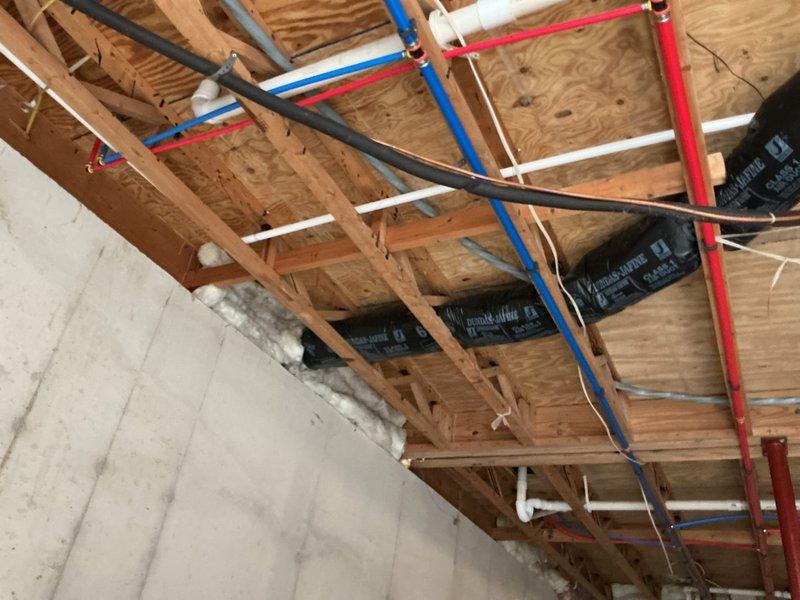 Completed full HVAC system installation including downflow furnace in basement area and Bryant condensing unit positioned on exterior pad with proper electrical disconnect. Field fabricated return air filter rack and integrated system with existing PEX plumbing infrastructure in unfinished ceiling space, ensuring proper clearances and code compliance throughout installation.