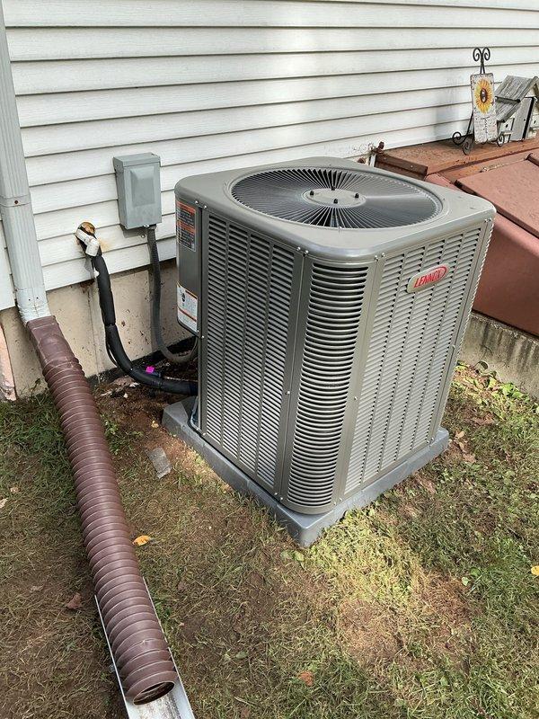 Completed full HVAC system installation including downflow furnace in basement area and Bryant condensing unit positioned on exterior pad with proper electrical disconnect. Field fabricated return air filter rack and integrated system with existing PEX plumbing infrastructure in unfinished ceiling space, ensuring proper clearances and code compliance throughout installation.