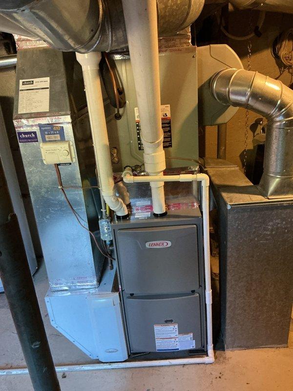 Installed Lennox ML196UH070XE48B high-efficiency furnace in basement mechanical room with complete ductwork connections and S200 programmable thermostat. Unit was positioned and leveled, gas line connected, supply and return plenums attached to existing ductwork infrastructure, and condensate drain lines installed. System was tested for proper operation, airflow verified, and thermostat programmed for optimal performance.