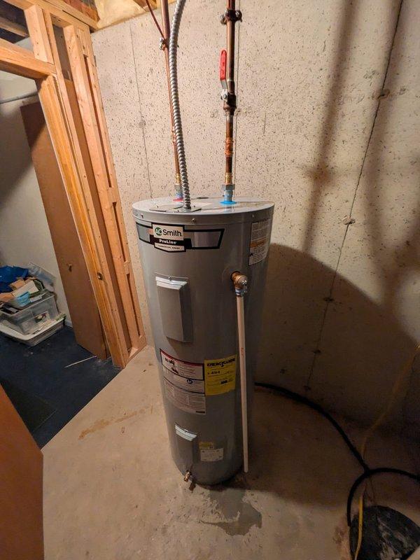 Responded to service call for 27-year-old AO Smith ProMax traditional tank-style water heater experiencing operational issues. Upon inspection, documented existing unit condition with model number HX35-NC2W-XJNW, noting age significantly exceeds typical 10-12 year lifespan for residential tank water heaters. Assessed all visible connections, piping, valves, and electrical components; photographed unit specifications and installation for service records. Provided homeowner with professional assessment and recommendations regarding unit replacement due to advanced age and potential for imminent failure.
