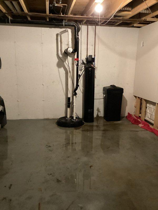 Responded to service call for basement bathroom sump pump system with failed check valve. Upon arrival, found significant water pooling on basement floor due to check valve failure allowing backflow into sump basin. Diagnosed malfunctioning check valve in vertical discharge piping system. Replaced defective check valve with new unit, secured all connections with appropriate clamps and fittings, and tested system for proper operation. Verified pump cycling correctly, confirmed no backflow occurring, and ensured all discharge piping sealed properly. System restored to full functionality with proper drainage flow established.