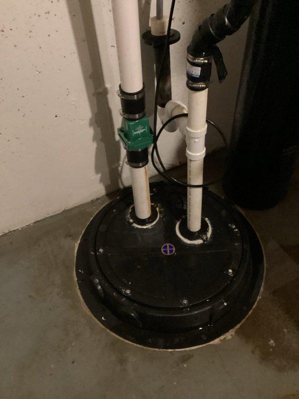 Responded to service call for basement bathroom sump pump system with failed check valve. Upon arrival, found significant water pooling on basement floor due to check valve failure allowing backflow into sump basin. Diagnosed malfunctioning check valve in vertical discharge piping system. Replaced defective check valve with new unit, secured all connections with appropriate clamps and fittings, and tested system for proper operation. Verified pump cycling correctly, confirmed no backflow occurring, and ensured all discharge piping sealed properly. System restored to full functionality with proper drainage flow established.