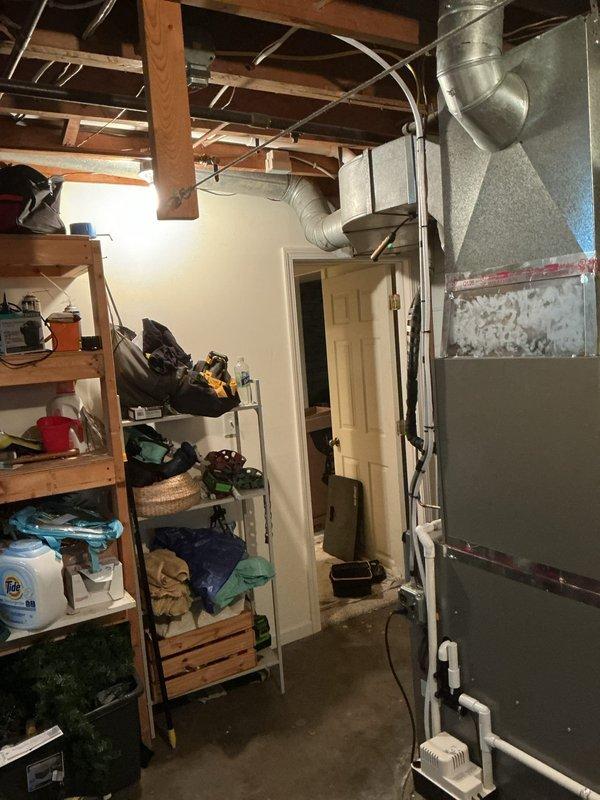 Completed full HVAC system installation in basement utility area, including EL297UH070XV36B furnace unit, ML13KC1-030-230 condenser, and CK40CT-30B-71-1610 evaporator coil with S200 thermostat. Installed all necessary metallic supply and return ductwork with proper transitions, white PVC condensate drainage and venting piping, and electrical connections. System tested and verified operational with all safety labels affixed and equipment secured to manufacturer specifications.