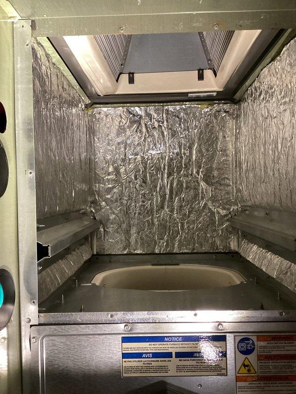 Responded to customer request for heating issue at office location. Upon inspection, determined heat exchanger on American Standard furnace required replacement. Ordered manufacturer-specified OEM replacement heat exchanger to maintain warranty compliance. Advised customer of 2-3 week lead time for part procurement due to factory-direct manufacturing and shipping requirements. Accessed air handler unit, documented existing system configuration and internal component condition. Unit interior showed reflective insulation in good condition with no visible deterioration. Photographed electrical wiring, blower motor assembly, and control components for reference during reassembly. Verified all warning labels and safety notices remain legible and intact on equipment housing.