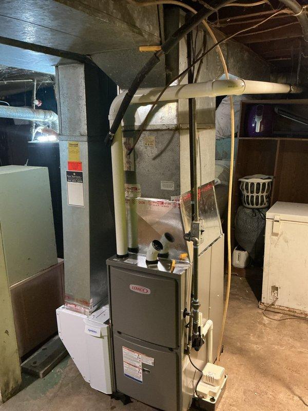 Installed a new Lennox ML196UH045XE36B high-efficiency gas furnace, connecting it to the existing sheet-metal supply plenum and trunk with foil-taped seams. Completed PVC combustion venting, black iron gas piping, condensate drain with pump, and electrical connections, and integrated an Aprilaire unit at the return side. Labeled the equipment and ductwork and left the work area clean.