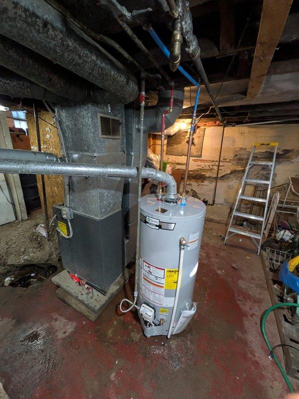 Installed a new A. O. Smith gas tank-style water heater per the approved quote, connecting copper and PEX water supply lines, the flexible gas line, and the flue to the existing venting. Performed concrete excavation in the basement floor to address the work area, then verified connections and system operation.