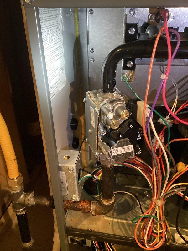 Performed planned maintenance on three gas furnaces (one approximately 14 years old, two approximately 1 year old), including electrical connection inspection, motor voltage and amp draw measurements, capacitor testing, ignition and gas system evaluation with manifold pressure checks, cleaning, and thermostat calibration. Completed the heating system diagnostic checklist for each unit and verified overall system operation and comfort. Noted heavy rust and corrosion on the black iron gas piping elbow near the gas valve assembly, which should be monitored and addressed to prevent a potential gas leak.
